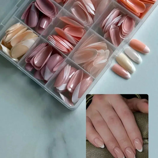 Set of false nails in various colors in a clear organizer with a close-up of hands wearing the nails.