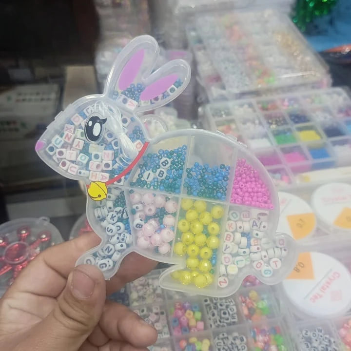Bead organizer shaped like a rabbit with colorful beads inside, held by a hand.