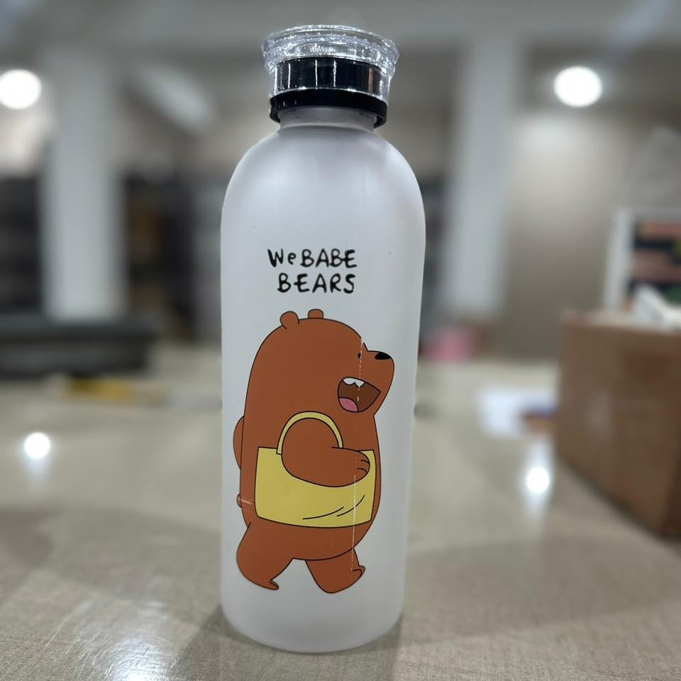 Clear water bottle with a cartoon bear design and text on a blurred indoor background
