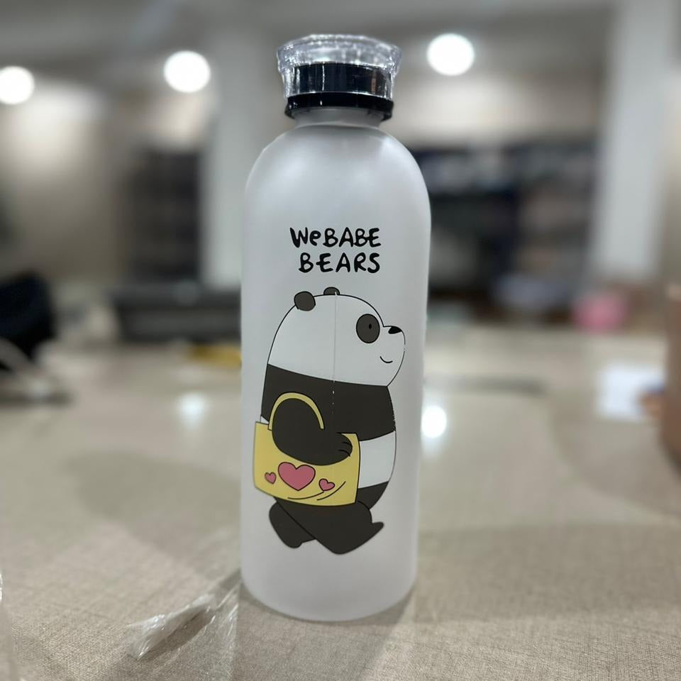 White water bottle with panda design and 'WE BABE BEARS' text on a blurred indoor background