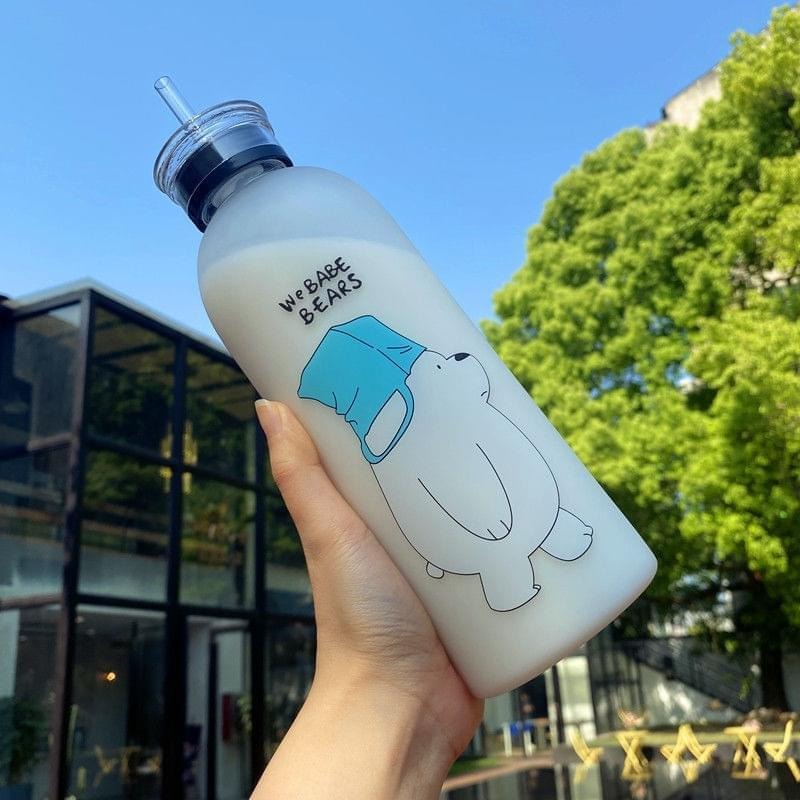 Person holding a white water bottle with a bear design and 'We Bare Bears' text outdoors.