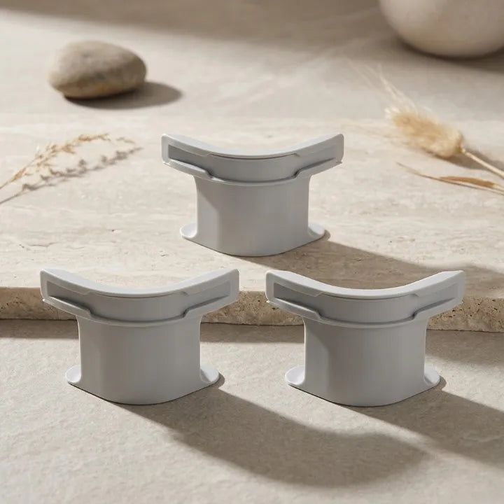 Three gray stone-like stools on a neutral background