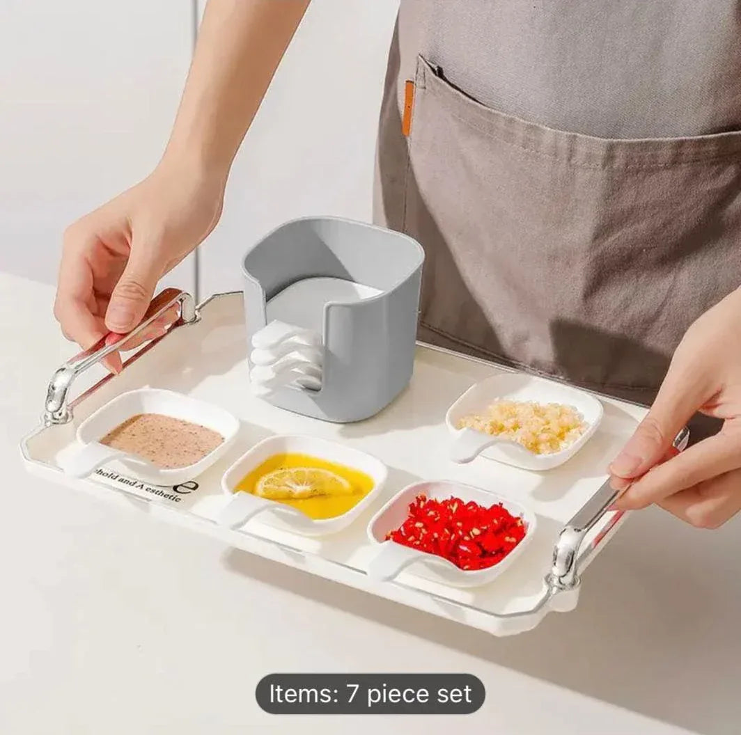 7-piece set of polished white plastic sauce dishes arranged on a wooden dining table for steak sauce and seasonings.