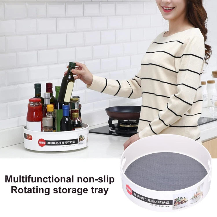 Multifunctional non-slip rotating storage tray in a kitchen setting with a woman holding bottles.