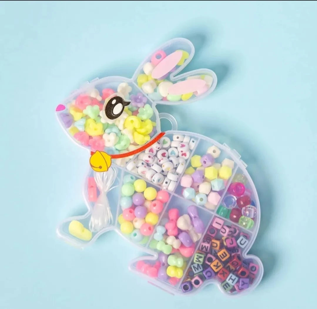 Bunny-shaped container with colorful beads and letters on a light blue background