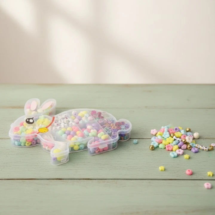 Bunny-shaped container with colorful beads on a wooden surface