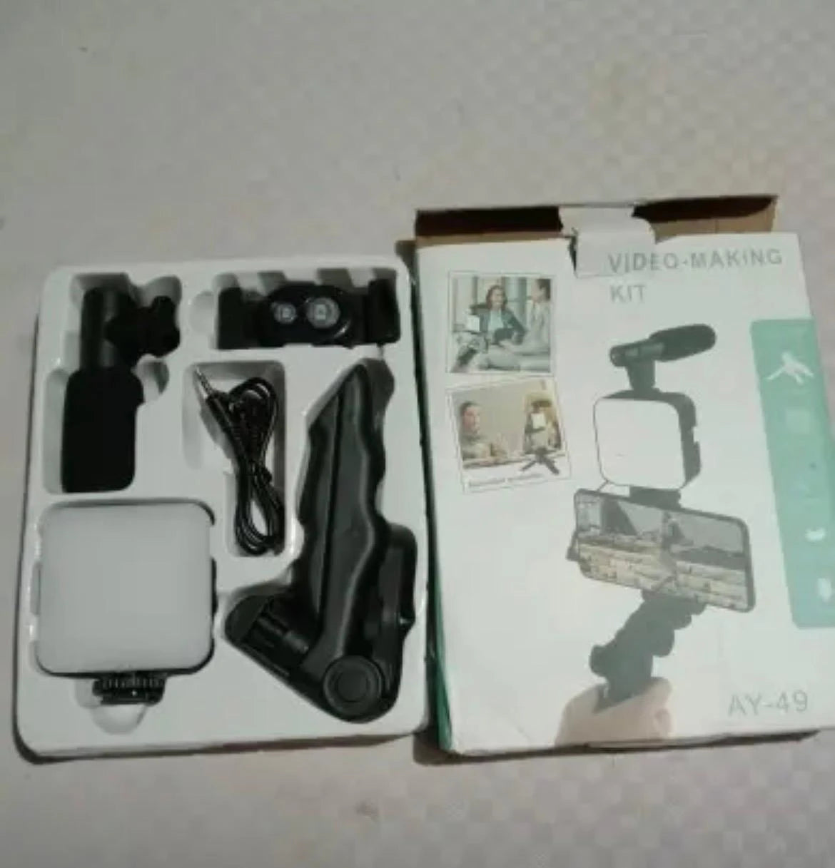 Video-making kit with various components on a white surface