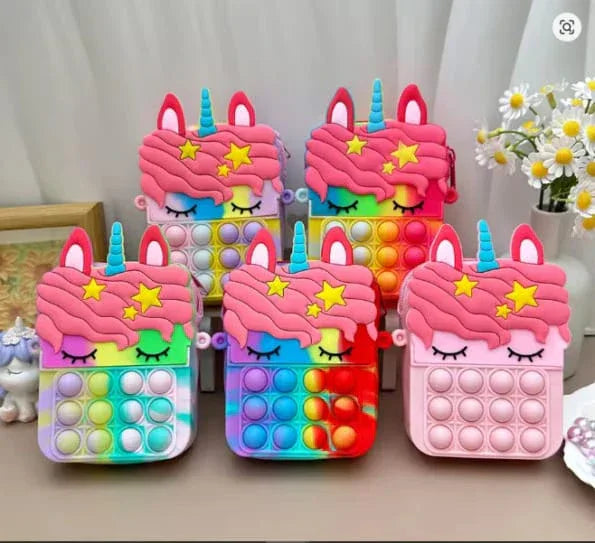 Colorful unicorn-themed pop-it fidget toys on a neutral background