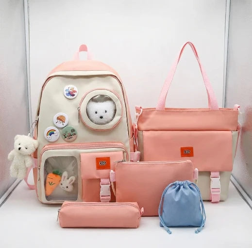 Set of pink bags including a backpack, tote bag, pencil case, and small pouch on a white background.