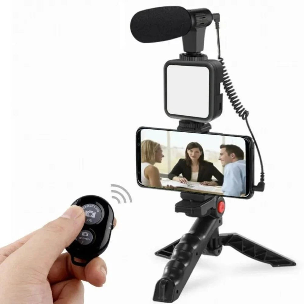 Handheld video recording setup with microphone, light, and remote control on a white background
