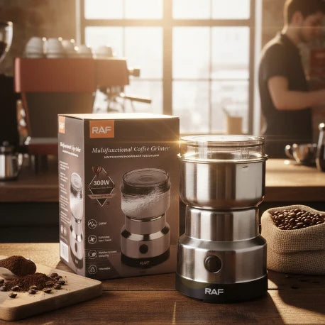 RAF multifunctional coffee grinder on a wooden table with packaging and coffee beans in the background.