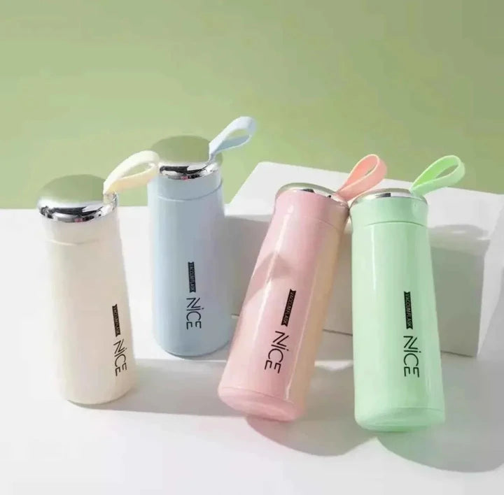 Four colorful water bottles with 'NICE' branding on a light green background