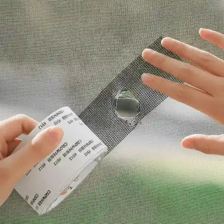 Person holding a screen repair kit over a damaged window screen
