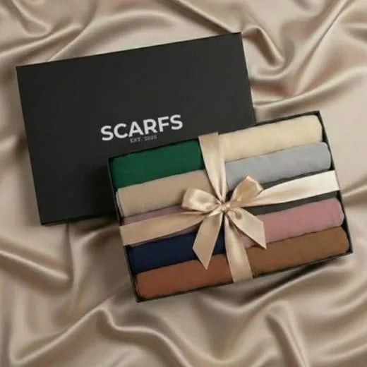 Box of scarves with a ribbon on a satin background