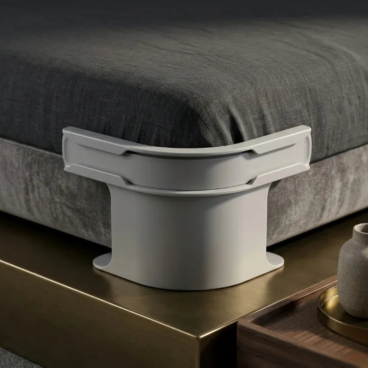 Gray bed riser on a bed with dark gray bedding
