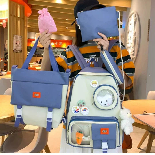 Person holding a blue and white backpack with a plush toy inside, in an indoor setting.