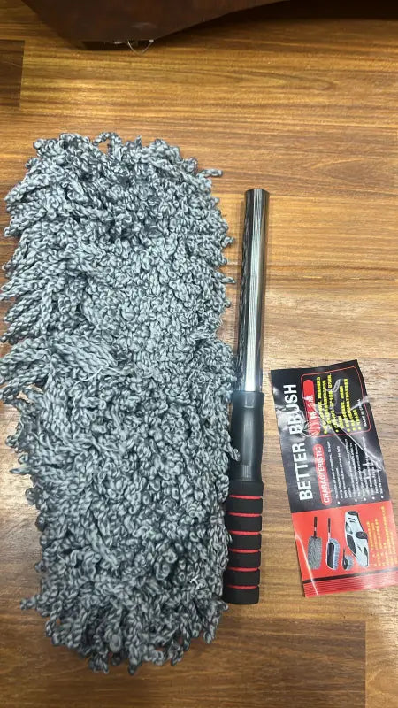 Microfiber cleaning brush with handle on a wooden surface, featuring the Better Brush brand.