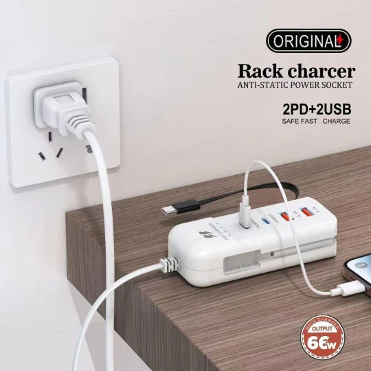 Rack charger with multiple ports plugged into a wall socket on a wooden surface.