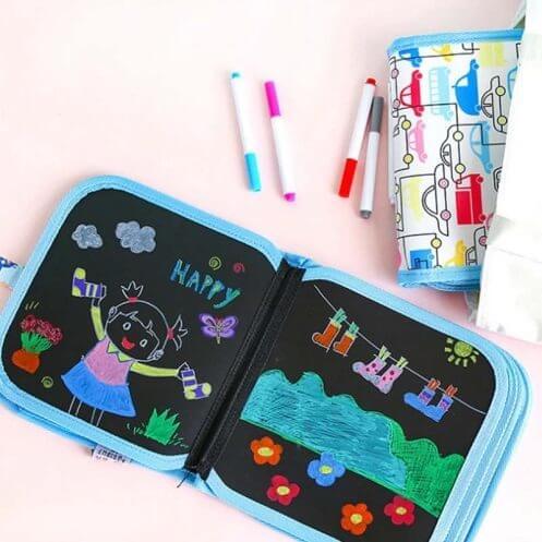 Kids erasable doodle magic book with 3 color markers being used for drawing.