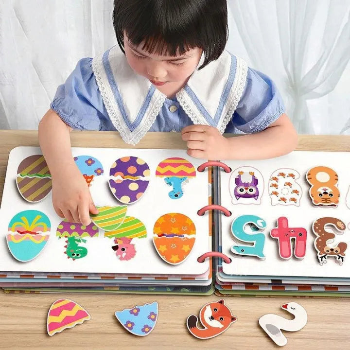 Child playing with a colorful alphabet puzzle on a wooden table.