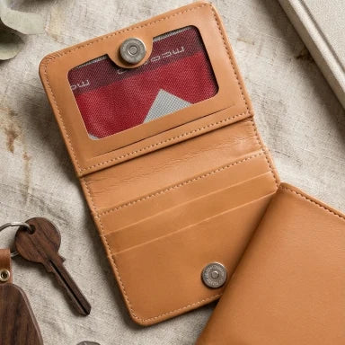 Brown leather wallet with card holder on a textured surface
